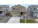 Charming two-story home featuring a well-manicured lawn, attached two car garage, and inviting front porch at 13144 E 109Th Pl, Commerce City, CO 80022