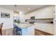 Modern kitchen with a granite island, stainless steel appliances, and ample white cabinetry at 13144 E 109Th Pl, Commerce City, CO 80022