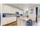 Bright kitchen features an island with bar seating, stainless steel appliances, and stone countertops at 13144 E 109Th Pl, Commerce City, CO 80022