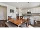 Bright kitchen featuring stainless steel appliances, a granite island, and an adjacent wooden dining table at 13144 E 109Th Pl, Commerce City, CO 80022
