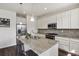 Updated kitchen with stainless steel appliances, granite countertops, island seating and ample cabinet space at 13144 E 109Th Pl, Commerce City, CO 80022