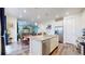 Open concept kitchen with an island, stainless steel appliances, and a seamless connection to the dining and living areas at 13144 E 109Th Pl, Commerce City, CO 80022