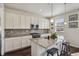 Modern kitchen boasts granite countertops, stainless steel appliances, and stylish pendant lighting at 13144 E 109Th Pl, Commerce City, CO 80022