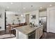 Open concept kitchen with granite island, stainless steel appliances, and wood-style flooring flowing into the dining area at 13144 E 109Th Pl, Commerce City, CO 80022