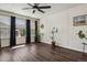 Bright living room with hardwood floors, stylish plants, and large windows at 13144 E 109Th Pl, Commerce City, CO 80022