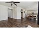 Open-concept living room with hardwood floors, seamlessly connected to the kitchen and dining area at 13144 E 109Th Pl, Commerce City, CO 80022