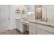 Elegant bathroom featuring double sinks, granite countertops, and floating shelves at 13144 E 109Th Pl, Commerce City, CO 80022