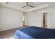 Large main bedroom featuring a tray ceiling, ceiling fan, carpet, and two bright windows at 13144 E 109Th Pl, Commerce City, CO 80022