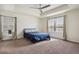 Spacious main bedroom with tray ceiling, ceiling fan, neutral carpet, and bright windows at 13144 E 109Th Pl, Commerce City, CO 80022