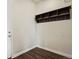 Mud room with wood-style flooring, hooks, and a storage shelf at 13144 E 109Th Pl, Commerce City, CO 80022