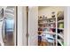 Well-stocked pantry with ample shelving and a variety of food items and storage containers at 13144 E 109Th Pl, Commerce City, CO 80022