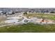 Aerial view of a large neighborhood park, showcasing playground, basketball court, and picnic areas at 13144 E 109Th Pl, Commerce City, CO 80022