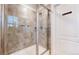 Modern shower with glass door and tiled walls, plus stylish fixtures at 13144 E 109Th Pl, Commerce City, CO 80022