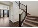 Elegant staircase with dark wood railing and carpeted steps, leading to the upper level at 13144 E 109Th Pl, Commerce City, CO 80022
