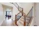 Bright foyer with a carpeted staircase and wood and iron railing leading to the upper level at 13144 E 109Th Pl, Commerce City, CO 80022