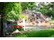 Beautiful backyard pond with a waterfall feature surrounded by lush landscaping at 4505 S Yosemite S St # 371, Denver, CO 80237