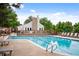 Community pool with lounge chairs, umbrellas, and a sundeck providing an ideal spot for relaxation at 4505 S Yosemite S St # 371, Denver, CO 80237