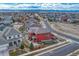 Elevated aerial view of a red house, landscaping, and suburban neighborhood at 21606 E Idyllwilde Dr, Parker, CO 80138
