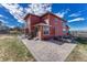 Expansive backyard of a two-story home featuring a brick patio with seating and a well-maintained lawn at 21606 E Idyllwilde Dr, Parker, CO 80138