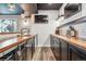 Basement bar with wood countertops, stainless appliances, and black cabinets at 21606 E Idyllwilde Dr, Parker, CO 80138