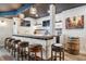 The basement features a custom bar with seating, hardwood floors, and plenty of lighting at 21606 E Idyllwilde Dr, Parker, CO 80138