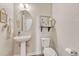 A cute half bathroom with a pedestal sink at 21606 E Idyllwilde Dr, Parker, CO 80138