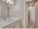 Clean bathroom with light-colored cabinets, a large mirror, and ample lighting at 21606 E Idyllwilde Dr, Parker, CO 80138