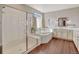 Bright bathroom with a soaking tub, glass enclosed shower, and double vanity sink at 21606 E Idyllwilde Dr, Parker, CO 80138
