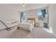Bright bedroom with soft gray walls, a large window, and a cozy reading nook at 21606 E Idyllwilde Dr, Parker, CO 80138