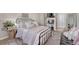 Comfortable bedroom with a patterned carpet, a black metal frame bed and plenty of pillows at 21606 E Idyllwilde Dr, Parker, CO 80138