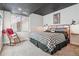 Cozy bedroom with black and white decor and a rocking chair next to a window at 21606 E Idyllwilde Dr, Parker, CO 80138
