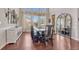 Elegant dining room with natural light, a modern chandelier, and a dark wood table set for dinner at 21606 E Idyllwilde Dr, Parker, CO 80138