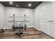 Functional home gym with weight rack, dark wood floors, and bright white trim at 21606 E Idyllwilde Dr, Parker, CO 80138