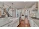 Bright kitchen with a large island, stainless appliances, white cabinets and hardwood flooring at 21606 E Idyllwilde Dr, Parker, CO 80138