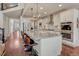 Spacious kitchen boasting a large island, stainless appliances, white cabinetry, and hardwood floors at 21606 E Idyllwilde Dr, Parker, CO 80138