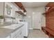 Well organized laundry room with open shelving, sink, washer, and dryer at 21606 E Idyllwilde Dr, Parker, CO 80138