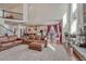 Open-concept living room showcases a cozy leather sofa and plenty of natural light at 21606 E Idyllwilde Dr, Parker, CO 80138