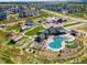 Aerial view of the community pool, clubhouse, park, and new homes on a sunny day at 1425 Hart Ln, Elizabeth, CO 80107
