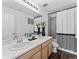 Bathroom featuring a double sink vanity, modern fixtures, and a shower with decorative curtain at 1425 Hart Ln, Elizabeth, CO 80107