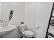 Well-lit half bathroom features a modern sink, mirror, toilet, and charming decor at 1425 Hart Ln, Elizabeth, CO 80107