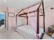 A bedroom featuring a canopy bed and floral wall art in a cozy space at 1425 Hart Ln, Elizabeth, CO 80107