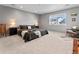 The primary bedroom features soft lighting, a neutral color palette, and a large window providing a view at 1425 Hart Ln, Elizabeth, CO 80107