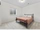 Bedroom with a metal bed frame and a well-lit window offering natural light at 1425 Hart Ln, Elizabeth, CO 80107