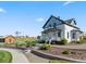 Exterior view of charming two-story model home with front porch, native landscaping, and farmhouse aesthetic at 1425 Hart Ln, Elizabeth, CO 80107