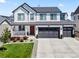 Beautiful two-story home with modern farmhouse style, featuring a red door, and a well-manicured front lawn at 1425 Hart Ln, Elizabeth, CO 80107