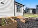 Raised garden beds and gravel in a backyard, offering opportunities for gardening and growing fresh produce at 1425 Hart Ln, Elizabeth, CO 80107