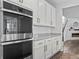 Modern kitchen featuring stainless steel double ovens, sleek white cabinets, and granite countertops at 1425 Hart Ln, Elizabeth, CO 80107