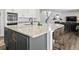 Spacious kitchen island with granite countertop and barstool seating, open concept to living room and fireplace at 1425 Hart Ln, Elizabeth, CO 80107