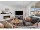 Comfortable living room with a corner fireplace, large sectional sofa, and plenty of natural light at 1425 Hart Ln, Elizabeth, CO 80107