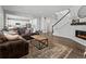 Cozy living room with hardwood floors, a fireplace, and an open concept layout to the kitchen at 1425 Hart Ln, Elizabeth, CO 80107